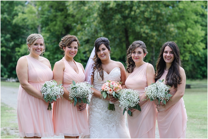 light pink bridesmaid dresses with bunches of babys breath
