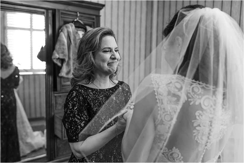 mother of bride putting finishing touches on daughter